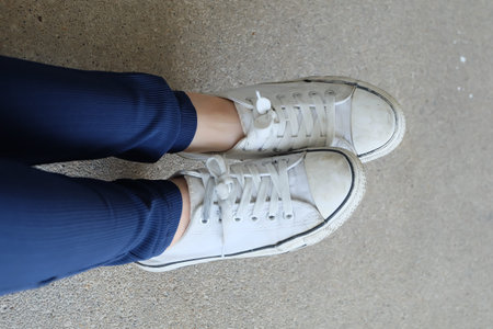 Fashion Young Woman in Blue Jeans and White Sneakers on the Streets Great for Any Use.