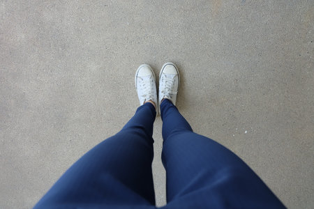 Fashion Young Woman in Blue Jeans and White Sneakers on the Streets Great for Any Use.