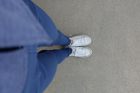 Fashion Young Woman in Blue Jeans and White Sneakers on the Streets Great for Any Use.