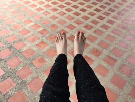 Female Legs and Feet on Tile Background Great For Any Use.の写真素材