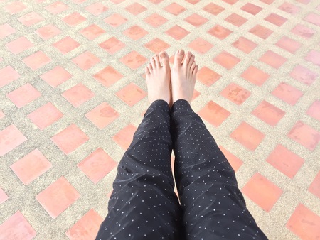 Female Legs and Feet on Tile Background Great For Any Use.の写真素材