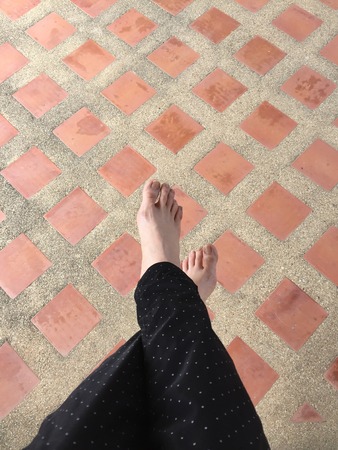 Female Legs and Feet on Tile Background Great For Any Use.の写真素材