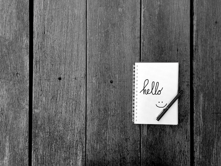 Hello Notebook with Pen on Old Wooden Table Great for Any Use.の写真素材