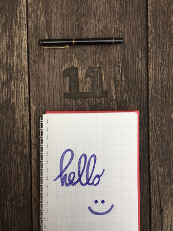 Hello Notebook with Pen on Old Wooden Table Great for Any Use.の写真素材