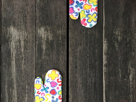 Kitchen Protective Colourful Flower Gloves on Wooden Background Great For Any Use.の写真素材