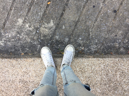 Woman's Legs in Blue Jeans and White Sneakers on Floor Great For Any Use.