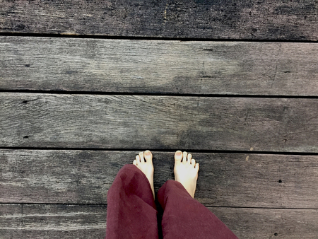Woman's Lay pants and Bare Feet on the Wooden Background Great For Any Use.の写真素材