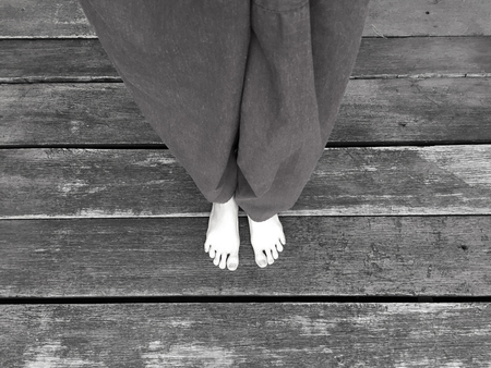 Woman's Lay pants and Bare Feet on the Wooden Background Great For Any Use.の写真素材