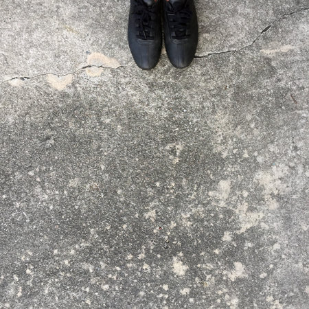 Black Shoes Standing on the Concrete Floor Great For Any Use.の写真素材