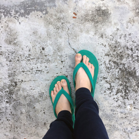 Feet of a Woman Wearing Green Sandals on the Old Concrete Floor Great For Any Use.