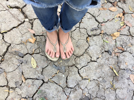 Selfie Close Up Of Girl's Feet Wearing Gold Sandals In The Ground Background Great For Any Use.