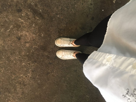 Closeup Photo of From Woman Wearing White Sneakers in The Street Great For Any Use.