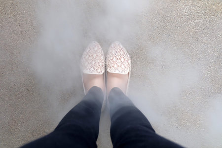 Close Up Of Girl's Feet Wearing Weave Sandals In The Ground Great For Any Use.の写真素材