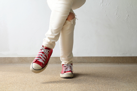Closeup Photo of From Woman Wearing Red Sneakers On The Concrete Floor Background Great For Any Use.の写真素材