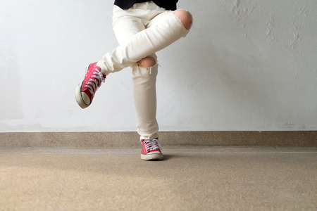 Closeup Photo of From Woman Wearing Red Sneakers On The Concrete Floor Background Great For Any Use.の写真素材