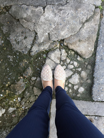 Close Up Of Girl's Feet Wearing Weave Sandals In The Ground Great For Any Use.