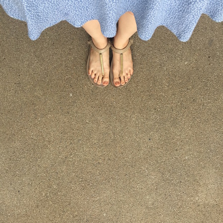 Female Feet Wear Sandals and Blue Dress on the Street Great For Any Use.の写真素材