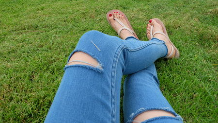 Feet Selfie in Gold Sandals Standing on Green Grass Background Great For Any Use.