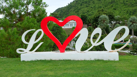 Love Heart Word on Cement on Green Grass Background Great For Any Use.の写真素材