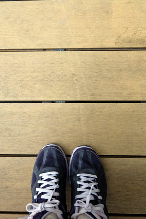 Young Woman of Running Shoes on Wooden Floor Background, Sport Violet Sneakers Concept Great For Any...