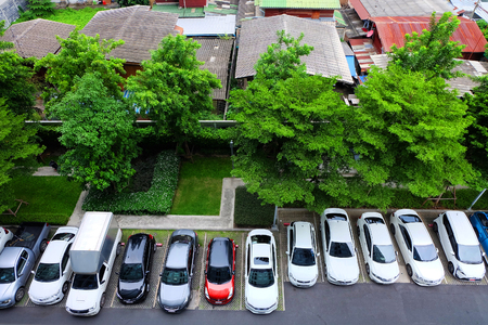 Aerial View of Car Park with Green Trees and Building Top View Background Great For Any Use.のeditorial素材