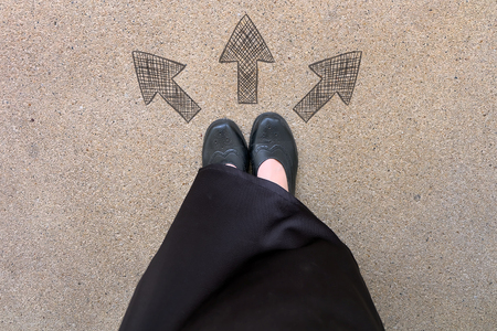 Drawn Direction Arrows, Female in Black Flat Shoes and Black Dress on the Concrete Background Great For Any Use.の写真素材