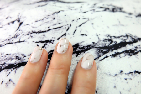 Beautiful Nail Polish, Manicure Nail. Close Up Granite Gray Nails on Fabric Background Great For Any Use.の写真素材