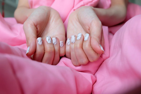 Beautiful Nail, Close Up Woman's Manicure Nails and Hands on Pink Fabric Background Great For Any...