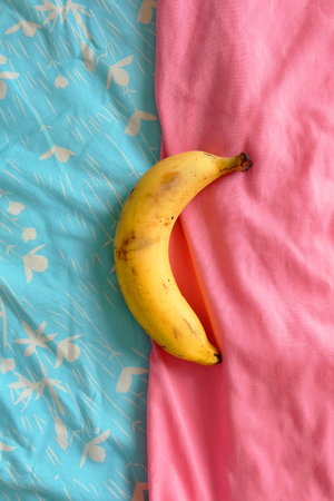 Ripped Banana, Close Up Banana Fruit on the Blue Half Pink Background Great For Any Use.の写真素材