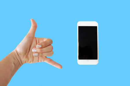Close Up Woman Hand Holding Phone with Black Screen on Blue Background Great For Any Use.