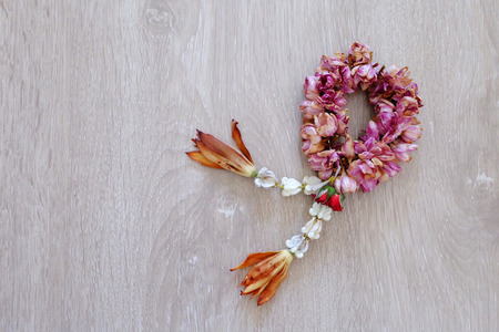 Close Up Dried Jasmine Garland Isolated on Wooden Floor Background Great For Any Use.の写真素材