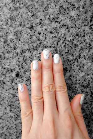 Hand and Nail Polish, Manicure Nail. Close Up Granite Gray Nails on Granite Background Great For Any Use.の写真素材