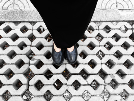 Close Up on Woman's Feet Wearing Black Sandals & Dress, Standing Commemorate on the Street Great For Any Use.の写真素材