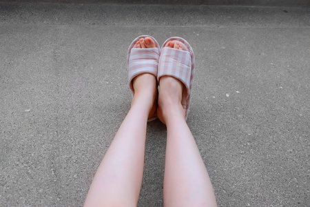Checkered Slippers, Close Up of Womanâs Pink Home Slippers Feet and Legs Background Great for Any Use.の写真素材