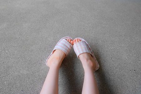 Checkered Slippers, Close Up of Womanâs Pink Home Slippers Feet and Legs Background Great for Any Use.の写真素材