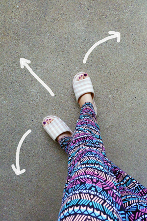 Womanâs Wear Home Slippers Feet with Arrows Drawn Choices Direction on Concrete Background Great for Any Use.の写真素材