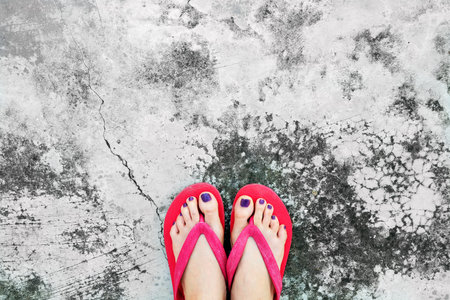 Nails Pedicure. Selfie Womanâ€™s Sandals Feet with Violet Nail Pedicure of Paint on Cement...