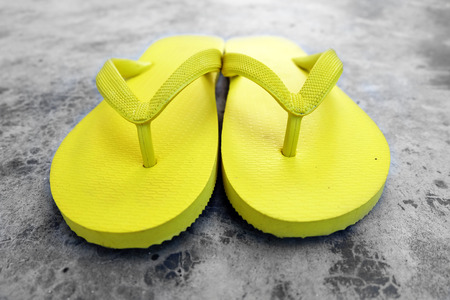 Flip Flop. Close Up Yellow Flip Flops Isolated on Cement Background Great for Any Use.の写真素材