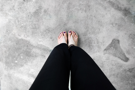 Close Up Nude Sandals. Selfie Womanâs in Black Pants and Sandals Feet with Violet Nail Pedicure of Paint on Cement Background Great for Any Use.の写真素材