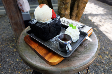 Charcoal Bread Buttered Toast, Honey Toast with Vanilla Ice Cream, Strawberry and Whipped Cream Dessert on Wooden Salver Background Great for Any Use.の写真素材