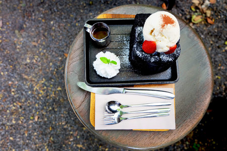 Charcoal Bread Buttered Toast, Honey Toast with Vanilla Ice Cream, Strawberry and Whipped Cream Dessert on Wooden Salver Background Great for Any Use.の写真素材
