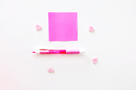 Close Up Blank Pink Paper Stick Note with Pink Pen Isolated on a White Background Great for Any Use.の写真素材