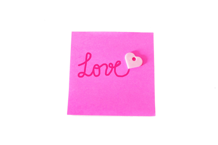 Pink Paper Stick Note With Love Text Written on a White Background Great for Any Use.の写真素材