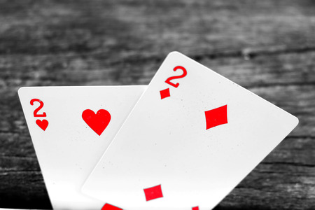 Two of Spades and Diamonds Playing card. Playing cards isolated On Wooden Background Great for Any Use.の写真素材