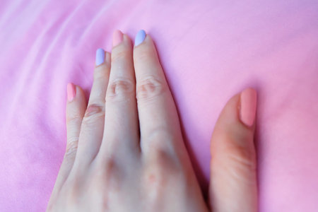 Beautiful Pink Nail Polish. Female Hands with Pink Nails Manicure on Pink Fabric Background Great...