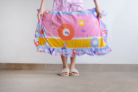 Checkered Warm Slipper. Female Standing in Pink Pajamas Pants and Shoes Holding A Pink Pillow on The...