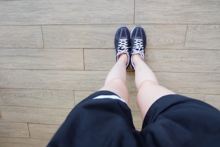 Running Shoes for Jogging. Selfie Woman in Violet Sneakers (Sport) on Wooden Floor Background Great For Any Use.の写真素材