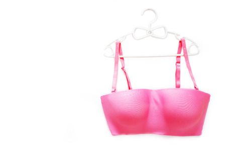 Beautiful Pink Underwear Isolated on White Color for Valentine is Day. Set of Accessory Lingerie (Bikini) Fabric on White Hanger. Woman is Lace Sexy Bra (Brassiere) on White Background, Top View.の写真素材
