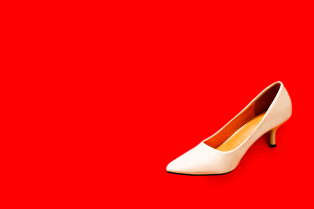 Woman Pastel Beige Color High Heel Shoes Isolated, Summer Trend. Fashionable Accessories Brown Shoe. The Pair of Beautiful Nude High Sandals, Footwear on Red Color Background with Copy space, Top Viewの写真素材