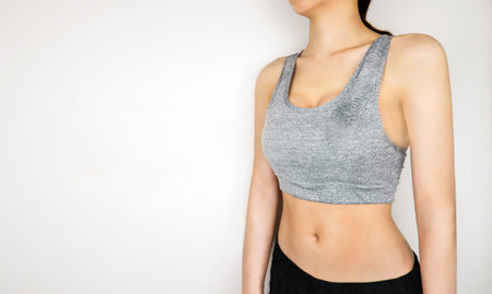 Fitness and Yoga Healthy Lifestyle Concept. Sporty Young Woman Wearing Gray Sport Bra with Muscular...